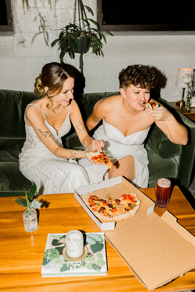 two brides eating pizza two brides eating pizza