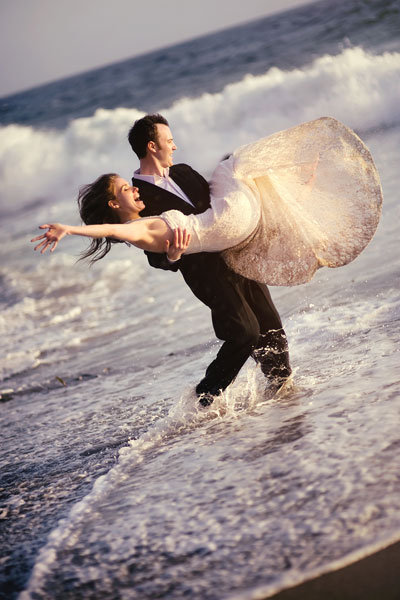 beach wedding photos in the waves